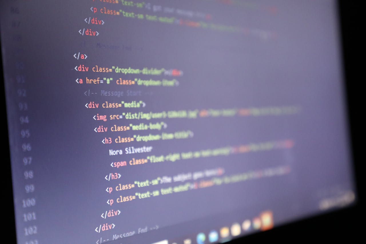 Illuminated HTML code displayed on a computer screen, close-up view.